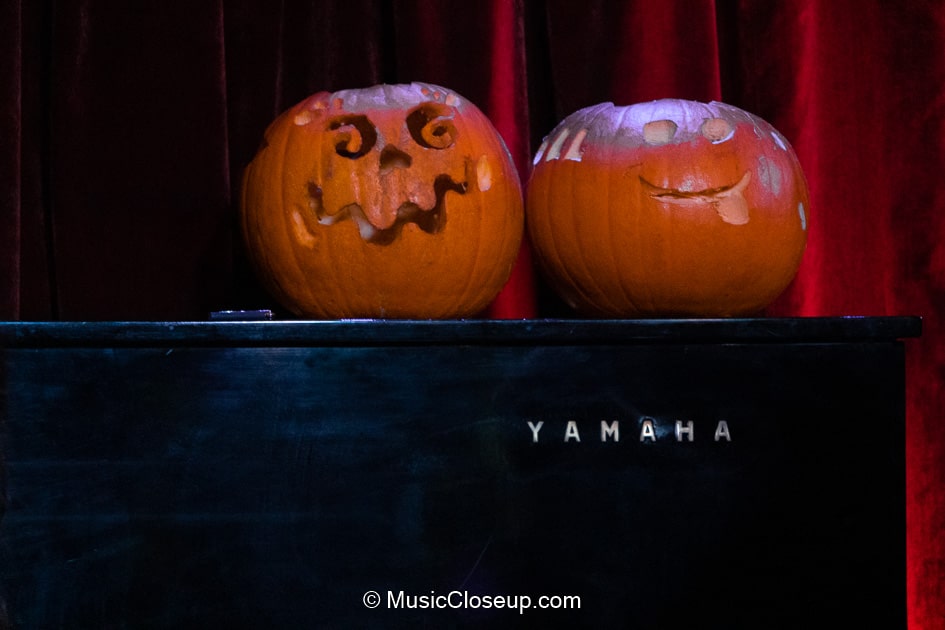 Carved Halloween pumpkins on a Yamaha piano