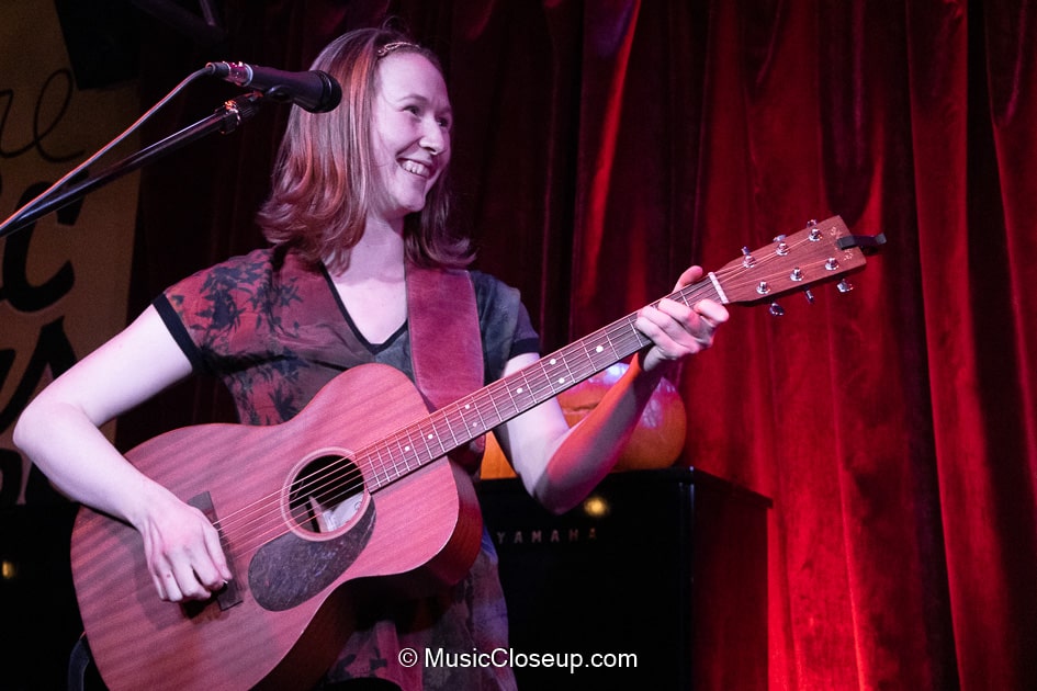 Saskia playing electro-acoustic guitar