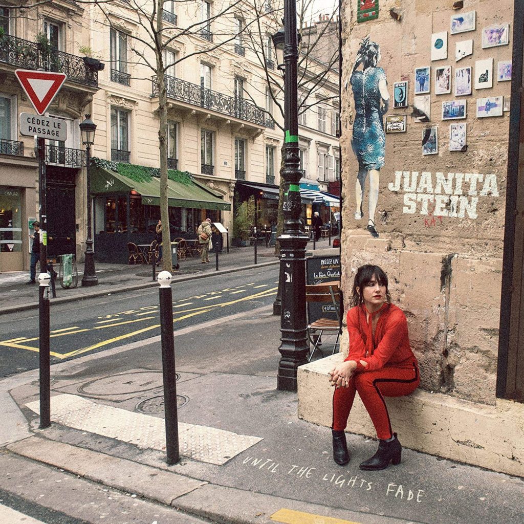 Juanita Stein sitting on a street corner