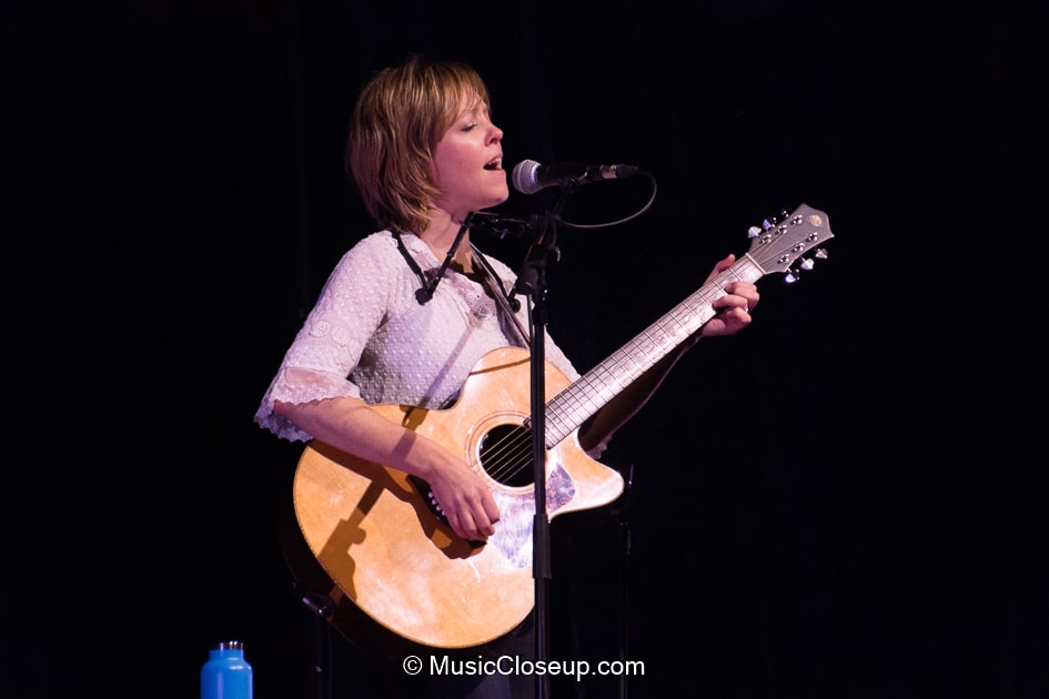 Emily Barker singing and playing guitar