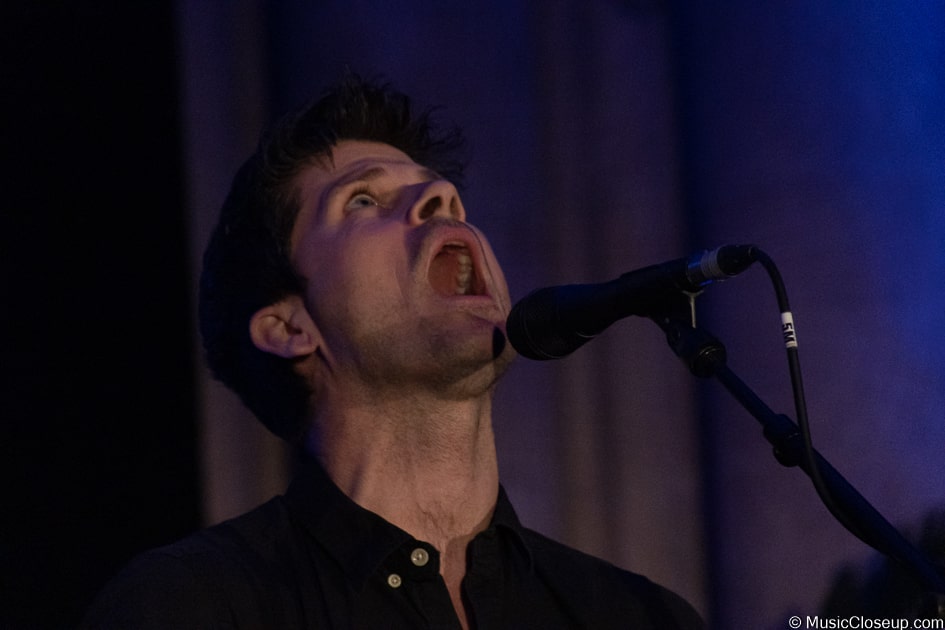 Seth Lakeman singing while looking up at Southwark Cathedral's ceiling